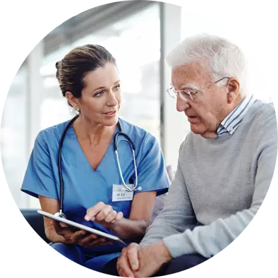 Clinician holding tablet speaking to older man